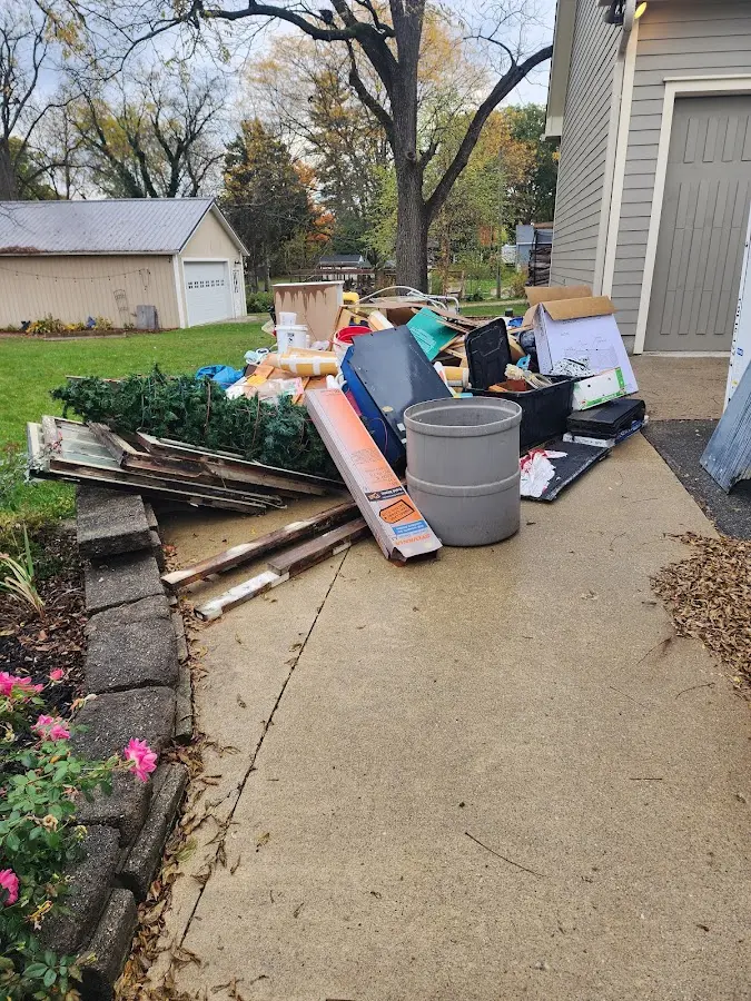 Dumpster being loaded with debris for Estate Cleanout Dumpster Rental in Eau Claire